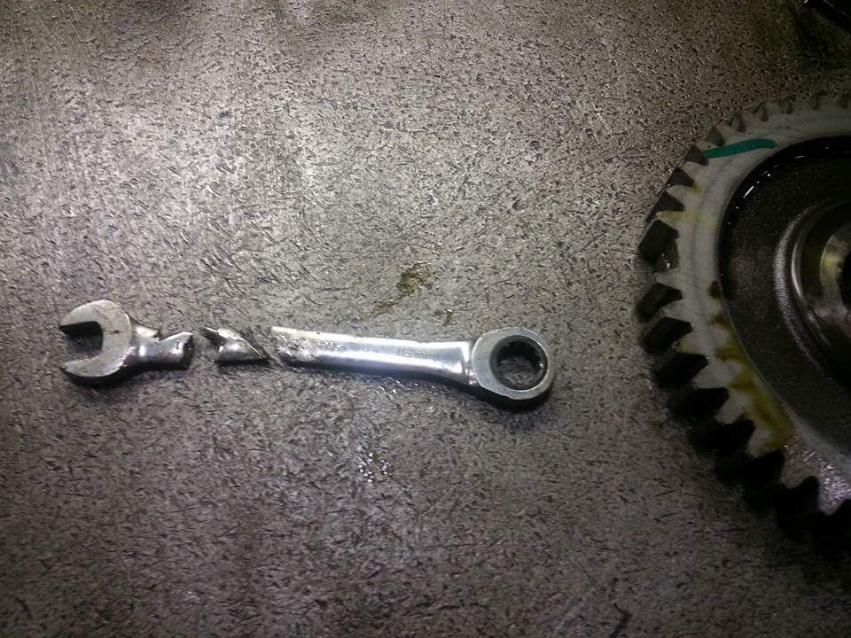 broken wrench next to broken gear